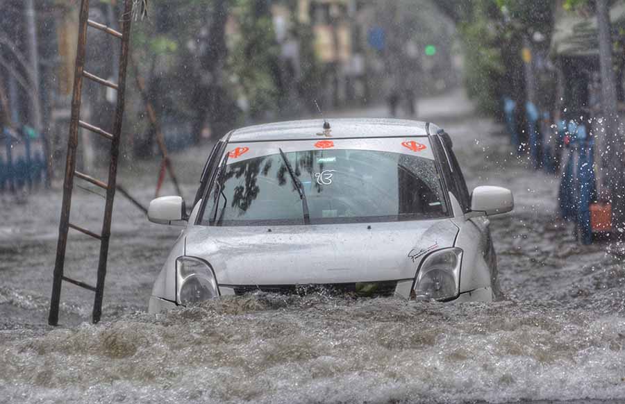 A car negotiates a stretch of Sukeas Street, infamous for waterlogging, near Manikatala