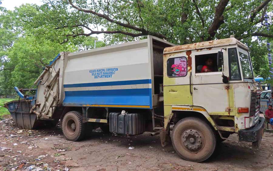 A Kolkata Municipal Corporation (KMC) compactor was seen at Maidan on Wednesday removing trees uprooted by the Remal Cyclone   