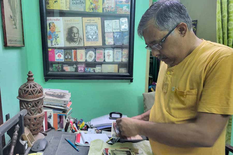 Chandranath Chatterjee sifts through his rare collection of rare documents, books, paintings, posters, vintage objects and artefacts at his Garia house.
