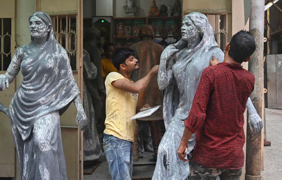 During the off-season, Kumartuli artisans work on several projects apart from making idols. In picture, two artists prepare a statue of a woman  