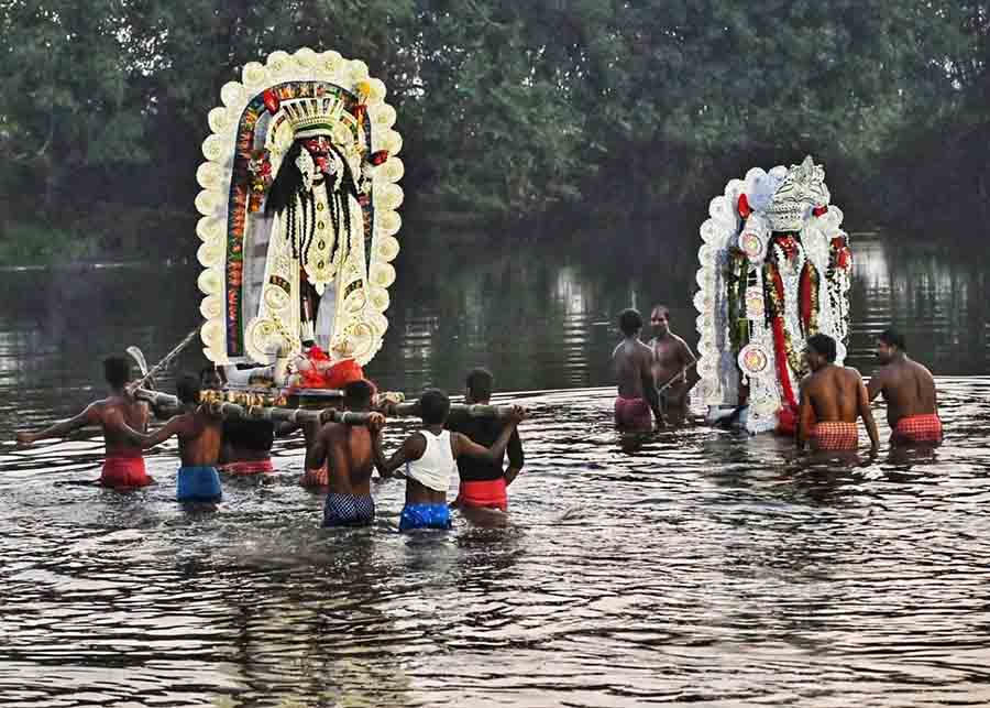 Devotees bid farewell to goddess Kali on Friday. In picture, immersion in a canal at Nadia district