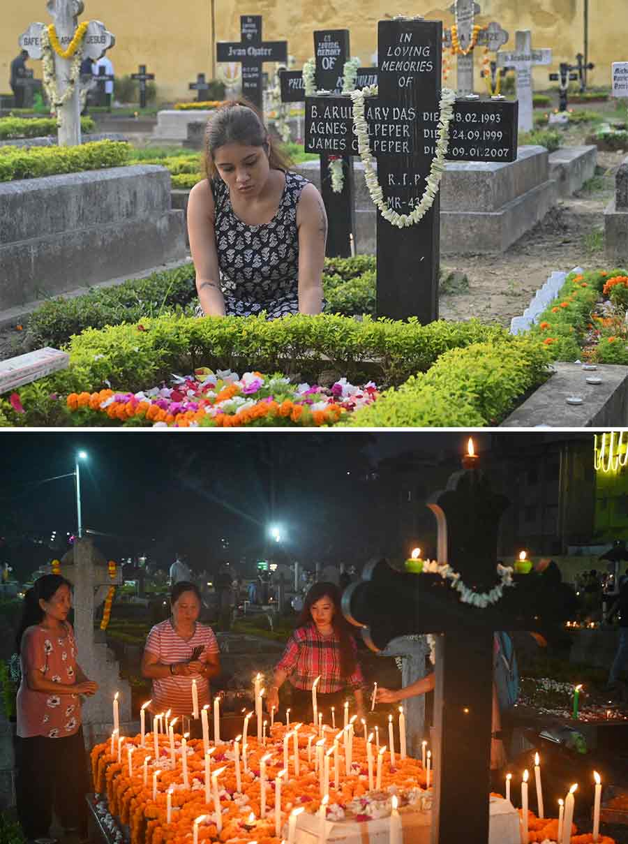 People light candles, offer flowers and pray at the graves of their loved ones at Bhowanipore Cemetery on All Souls Day