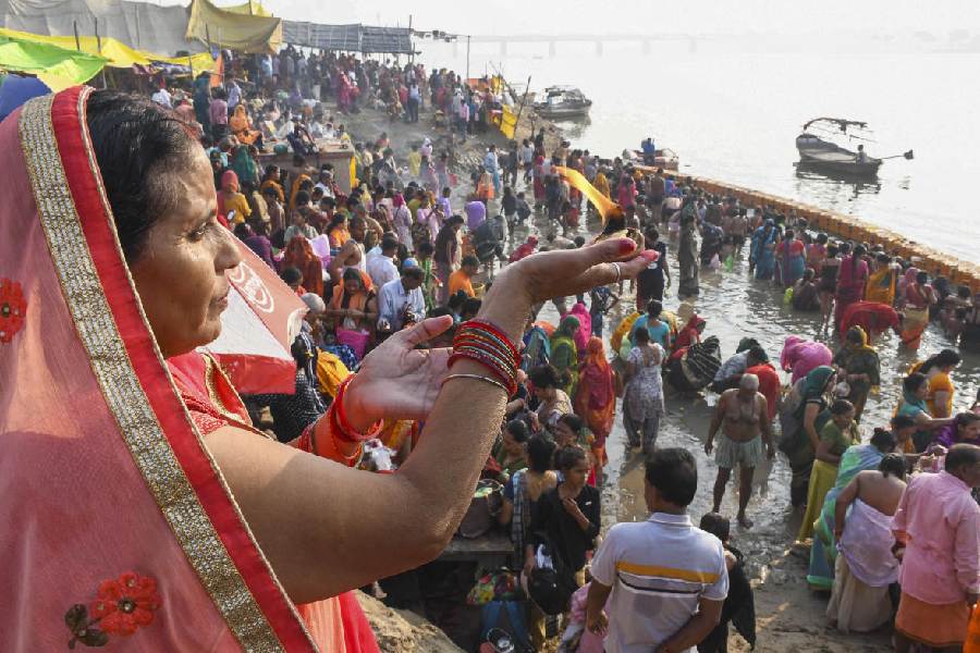 Devotees take bath in the Yamuna river and pray at Balhuaghat, in Prayagraj. PTI