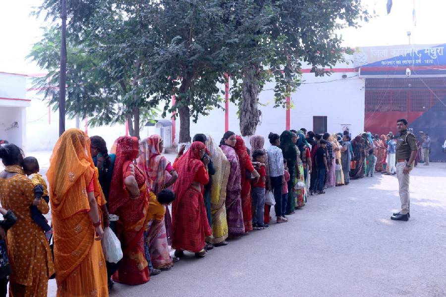 Sisters wait outside District Jail to meet their brothers, in Mathura. PTI