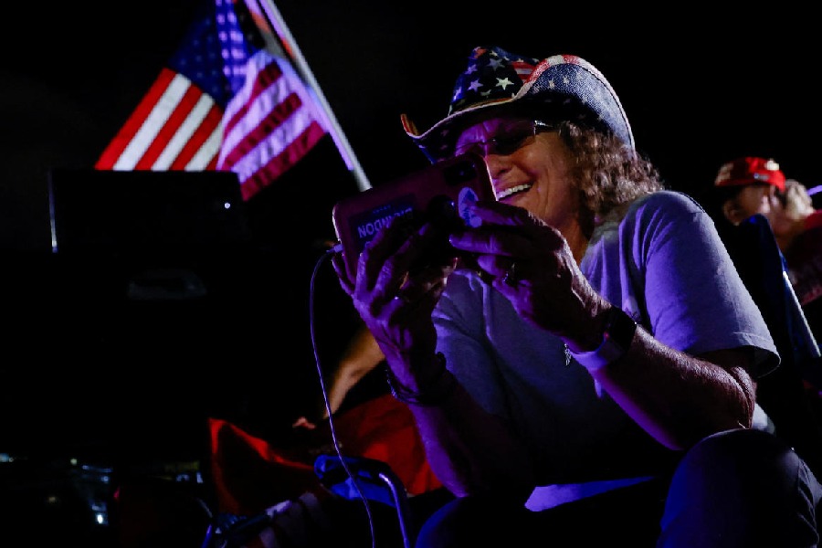 A supporter of Republican presidential nominee and former U.S. President Donald Trump reacts as she watches election updates on Election Day, near Mar-a-Lago, in Palm Beach, Florida, U.S., November 5, 2024.