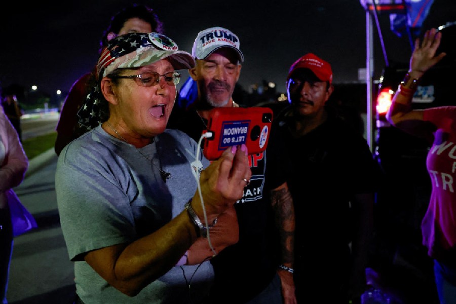 Supporters of Republican presidential nominee and former U.S. President Donald Trump react while watching election updates on Election Day, near Mar-a-Lago, in Palm Beach, Florida, U.S., November 5, 2024. 
