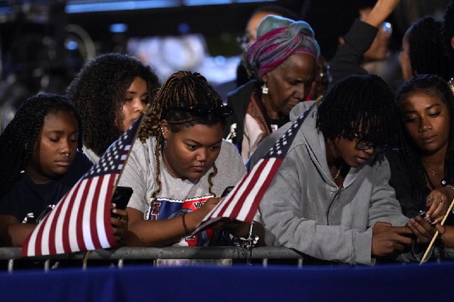 Attendees check their phones at the event held by U.S. Democratic presidential nominee Kamala Harris during Election Night, at Howard University, in Washington, U.S., November 5, 2024.