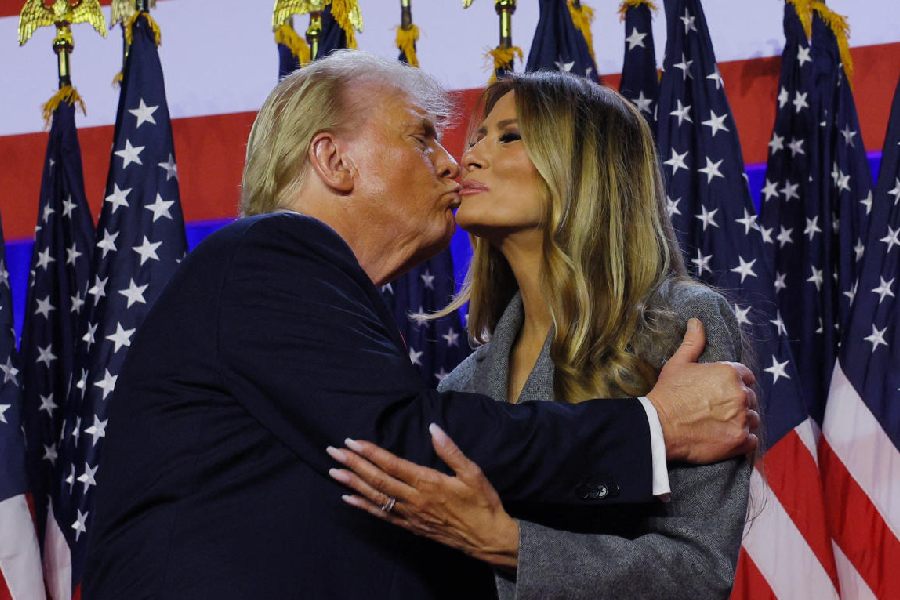 Republican presidential nominee and former U.S. President Donald Trump takes with his wife Melania Trump at his rally, at the Palm Beach County Convention Center in West Palm Beach, Florida, U.S., November 6, 2024. Reuters