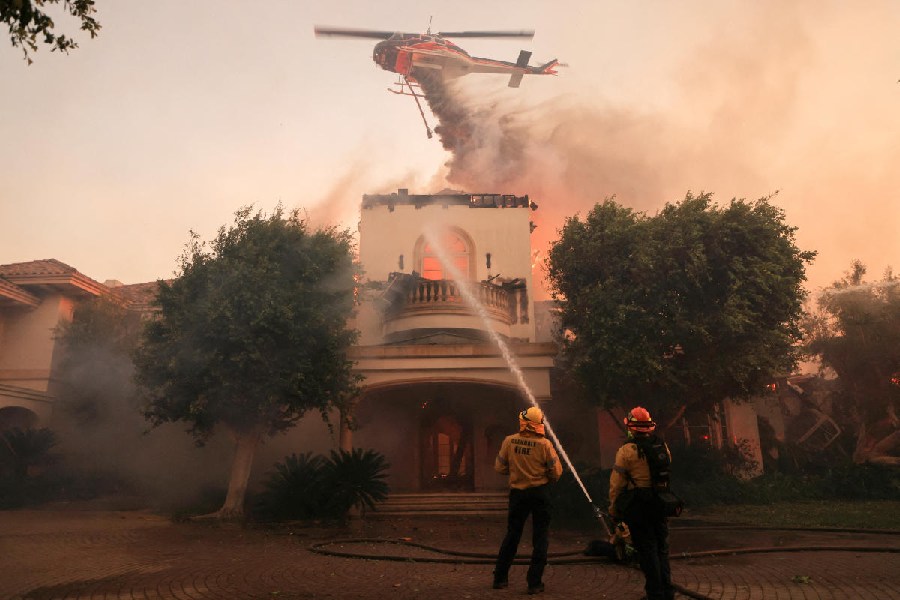 A helicopter drops retardant to control the fire, California, U.S. Reuters