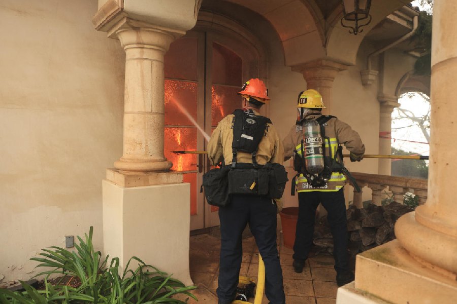 On-duty firefighters at the scene, in California, U.S. Reuters