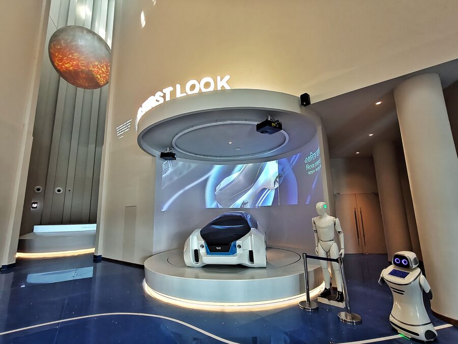 At the entrance, a smart electric vehicle doubles up as a vehicle of the future in the lobby-cum-atrium. A humanoid robot, which can rotate its neck, move its hands and speak, greets visitors on sensing human presence. Next to it stands a shorter robot. While there are two humanoid robots, there are six of the shorter ones, called Curio