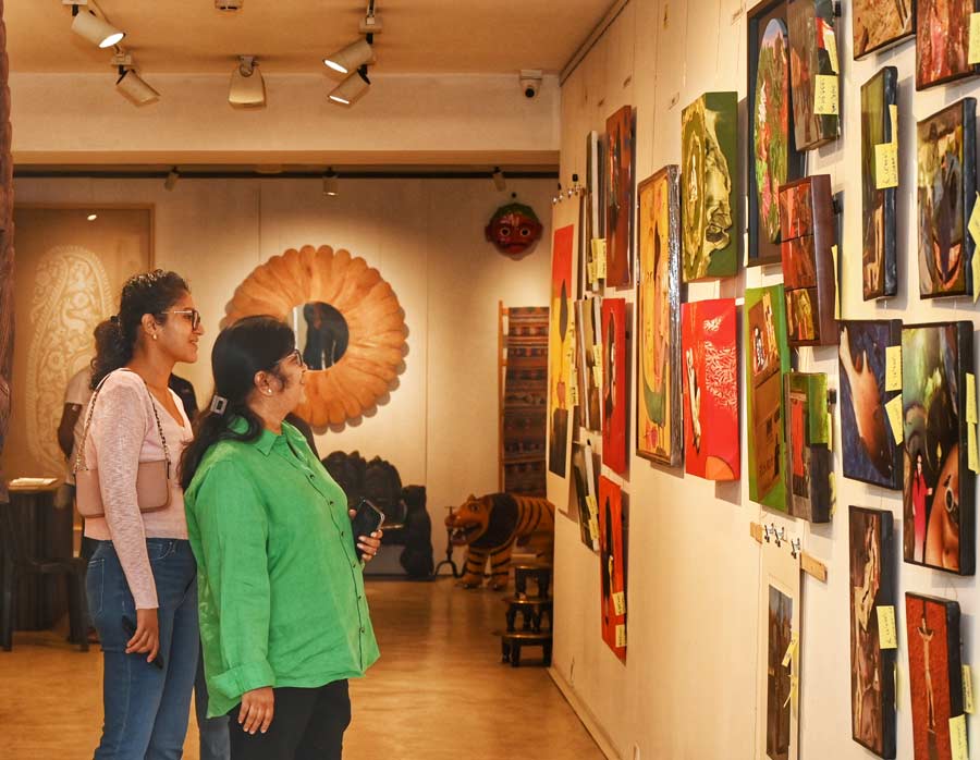 Visitors to CIMA Art Mela captured enjoying the art on display 