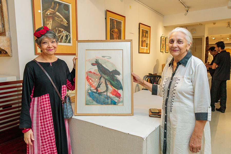 Pratiti Basu Sarkar (left) and Sudha Kaul pose with Madhuri Kapoor’s painting which she made with a headstick and a brush