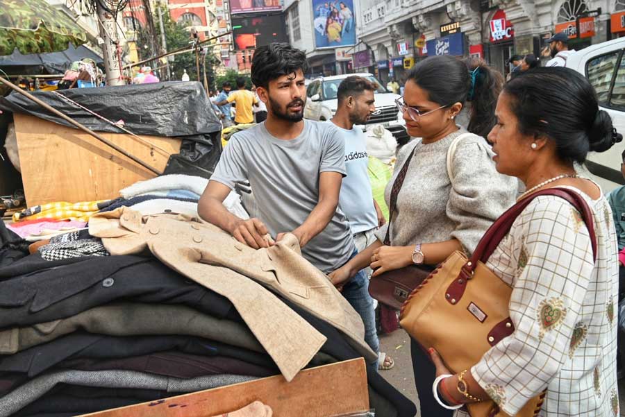 As the temperature dips, people shop for coats and blazers at New Market 