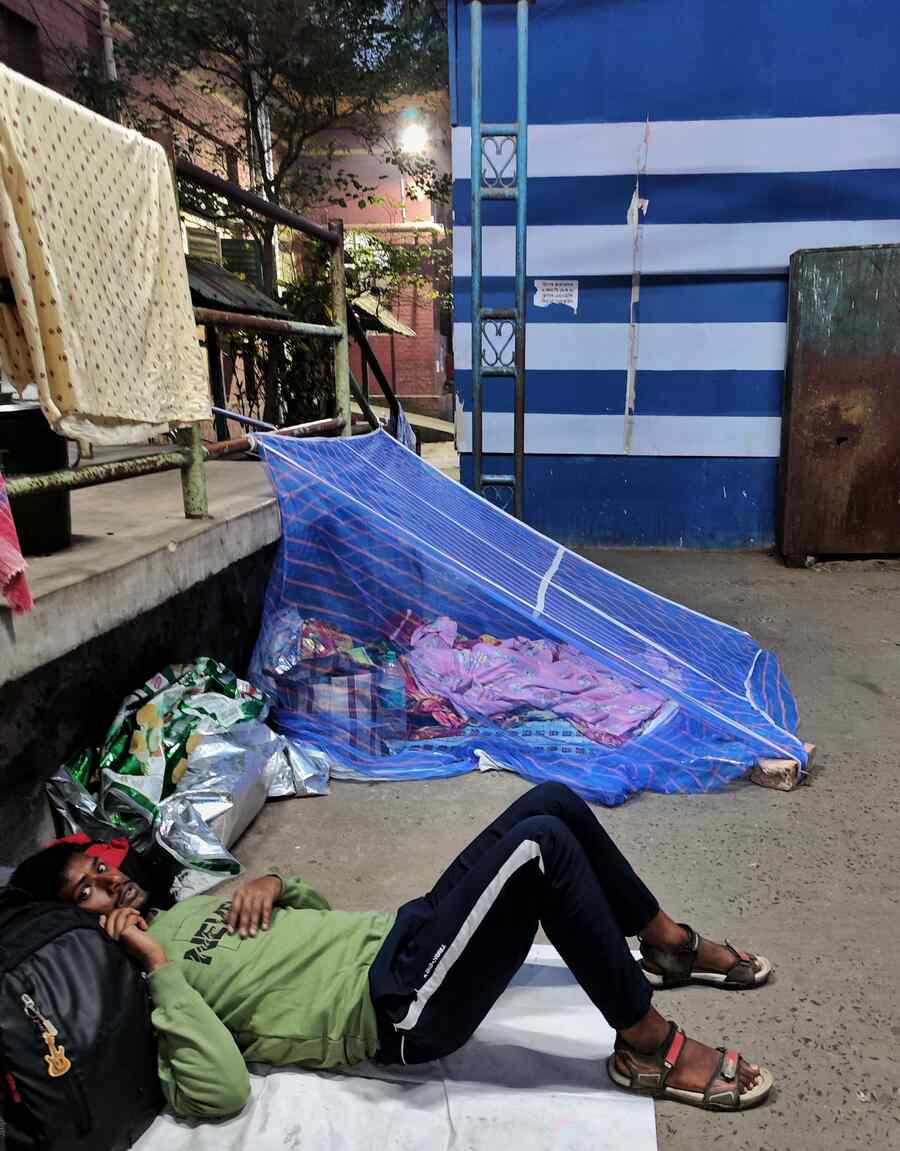 Family members of patients spend nights in empty spaces under the open sky at Sambhunath Pandit Hospital near Exide crossing