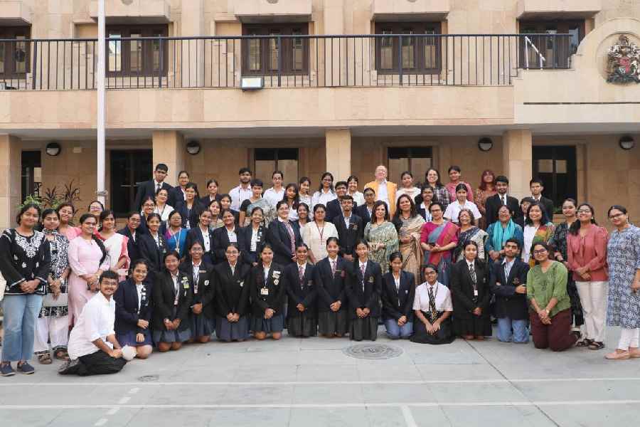 Students take a group picture with Andrew Fleming, British deputy high commissioner in Calcutta, after sharing their ideas on gender stereotypes.