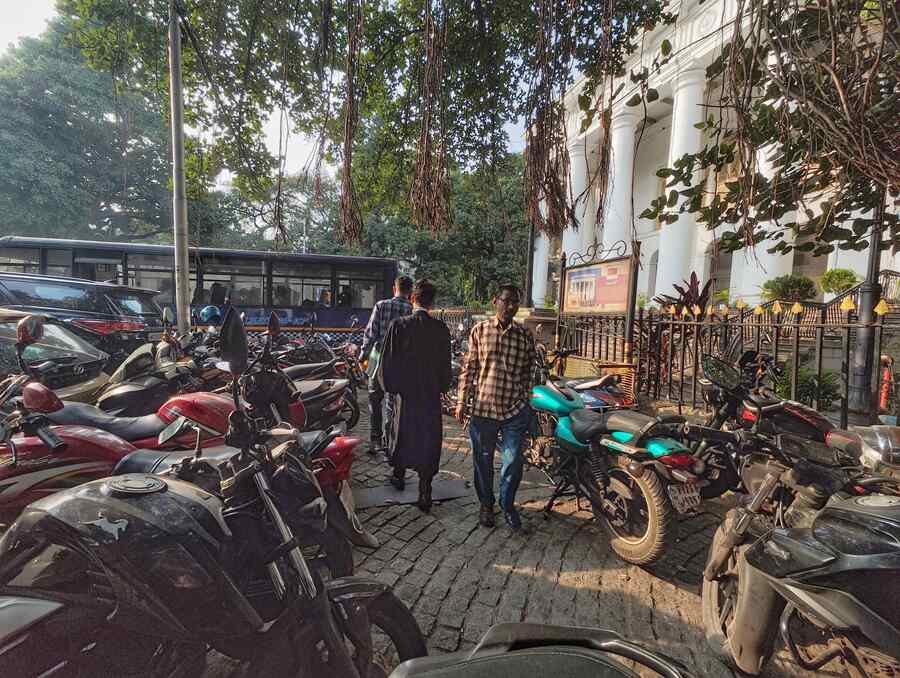 Cocking a snook at the no-parking rules of Kolkata Traffic Police, two-wheelers occupy the sidewalks in front of Town Hall