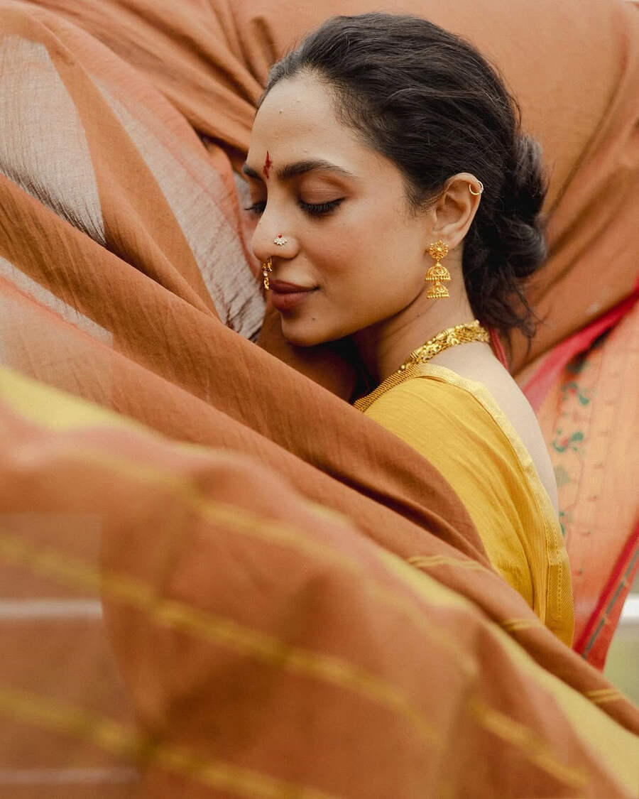 Sobhita tied her hair into a messy bun and opted for a red tilak on her forehead