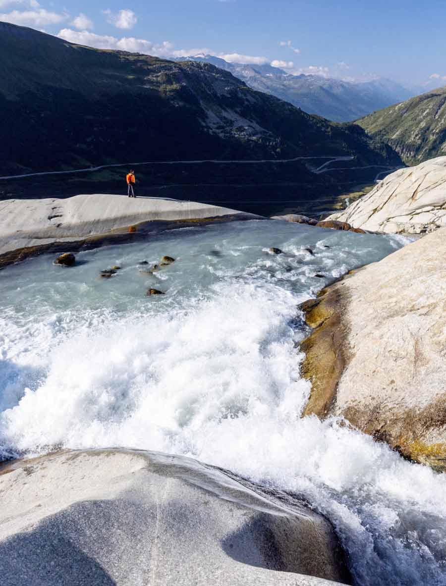Water flows down the valley at the source of the Rhone and its glacier in Obergoms.