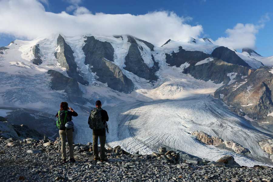 Hikers take a picture of Pers Glacier amid climate change, in Pontresina.