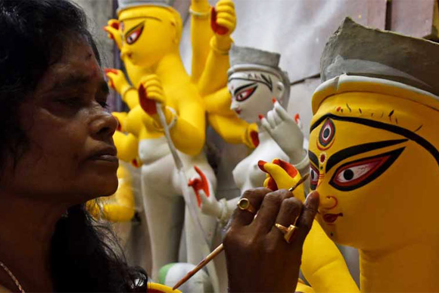 An artist paints the eyes of the goddess — ‘chokkhudaan’ — traditionally done on Mahalaya