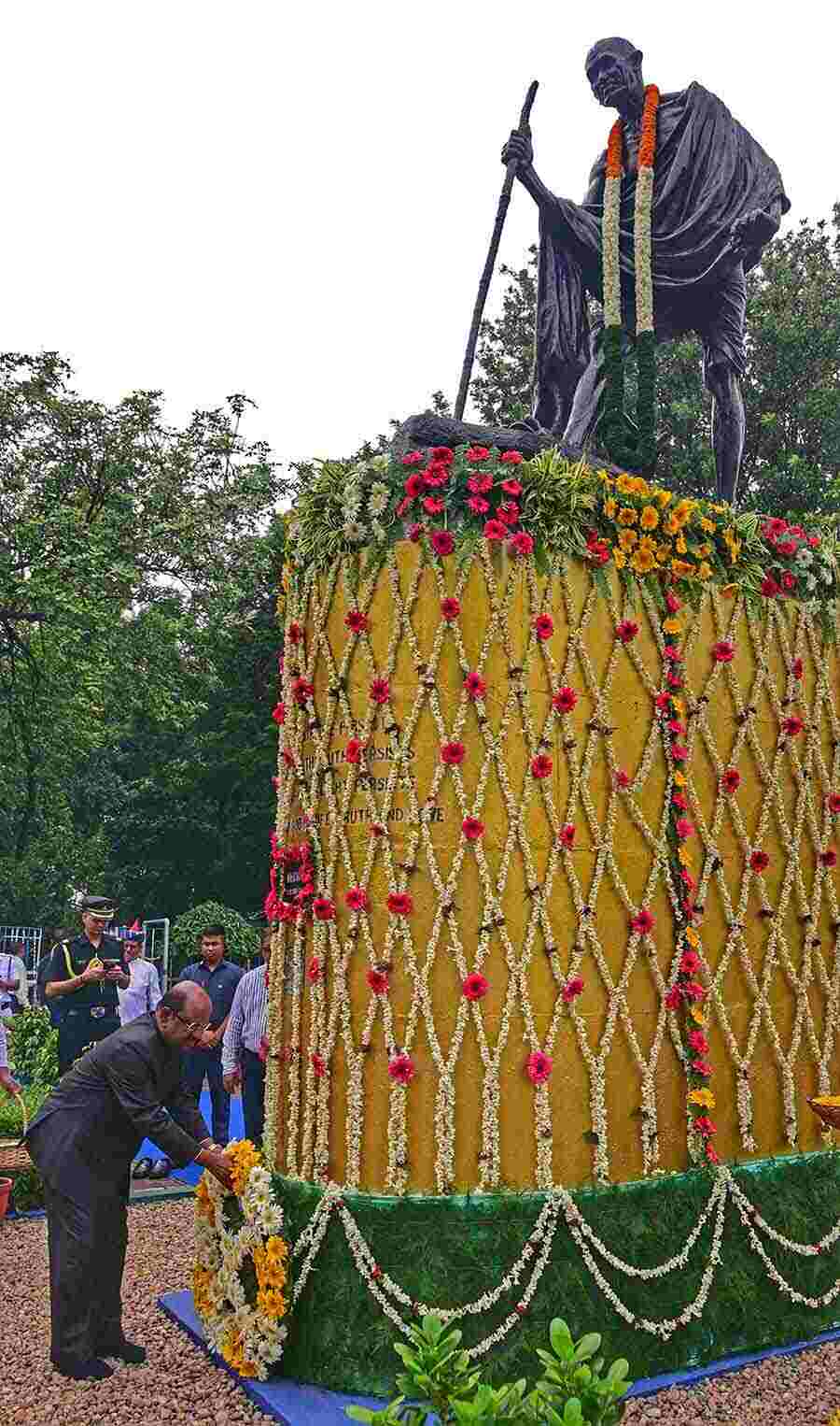 West Bengal Governor Dr CV Ananda Bose offers floral tributes at the base of the statue of Mahatma Gandhi at Mayo Road on Gandhi Jayanti