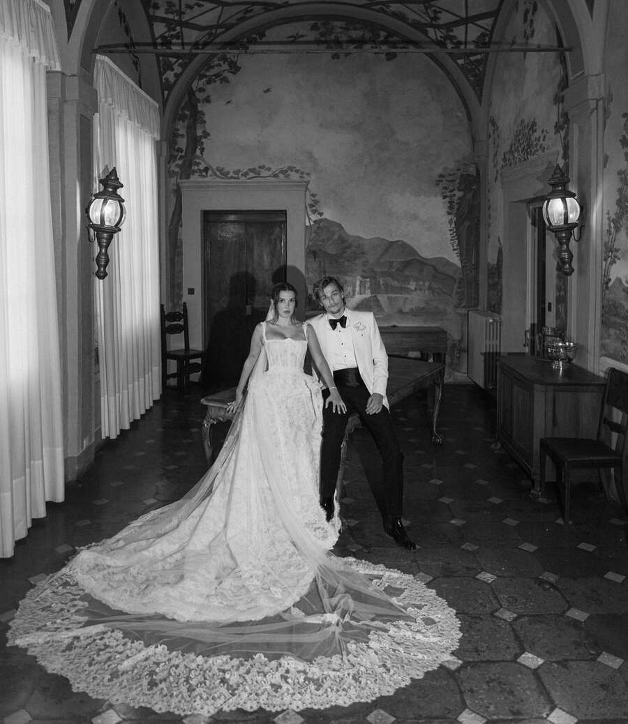 “Forever and always, your wife,” the 20-year-old actress captioned the Instagram carousel on Wednesday. Brown dazzled in a white lace Oscar de la Renta gown designed by Galia Lahav. It featured chic lace straps and a corseted bodice, which cascaded into a flowing fishtail skirt. She completed her bridal look with a long, delicate tulle veil adorned with intricate lace detailing. Bongiovi, on the other hand, looked dapper in a classic white tuxedo jacket paired with a black bow tie. 