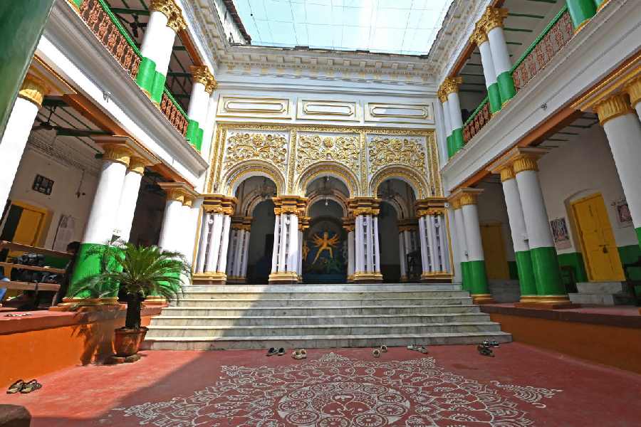 The traditional thakurdalan at Ramgopal Saha House is adorned with alpona on the red floor.