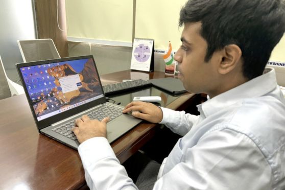 Piyush Rakhecha in his element, navigating the professional world with assistive technology, proving that no obstacle is too great when determination leads the way.