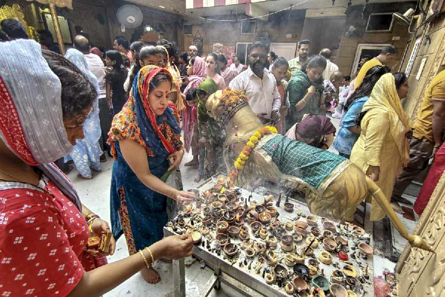 FLAME OF FAITH: Women light diyas at the Mata Longa Wali Devi temple on the first day of Navratri in Amritsar, Thursday, October 3