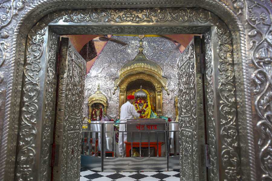 WAY OF THE WORSHIPPER: A priest  in Jammu performs worship at the Bave Wali Mata Mandir Wednesday, Oct 2