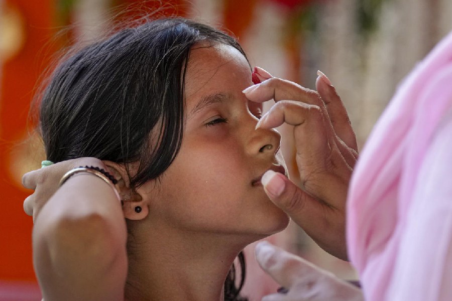 ANOINTMENT: A young devotee in New Delhi is anointed at the Jhandewala Devi Mandir, Thursday, Oct. 3, 2024.