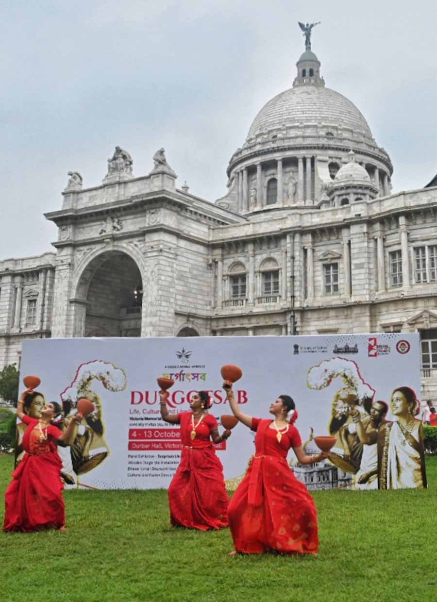 The white Victoria Memorial Hall provided the perfect backdrop to a bevy of young women clad in red saris performing a ‘dhunuchi ’ dance on the greens to usher in the festivities in town on Saturday