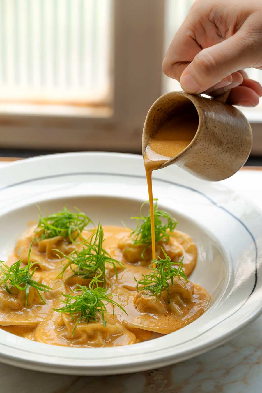 King Scampi Ravioli in Coconut Curry Bisque: The star of this dish is the bisque because when you’re working with golda chingri or scampi, you want to capture its magic in every bite. ‘The buttery tail meat is hidden inside the delicate ravioli, so diners can enjoy the magic of ‘ghilu’ (scampi brain) without them having to see an entire prawn on their plate,’ says Auroni.