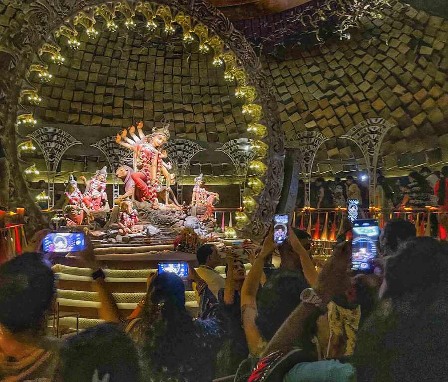 As Saptami night transitioned into Ashtami, pandal-hoppers were seen across the city, snapping photos of Puja celebrations on their smartphones. In the picture, visitors at Dakshinpara Sarbajanin Durga Utsav pandal in Dumdum   
