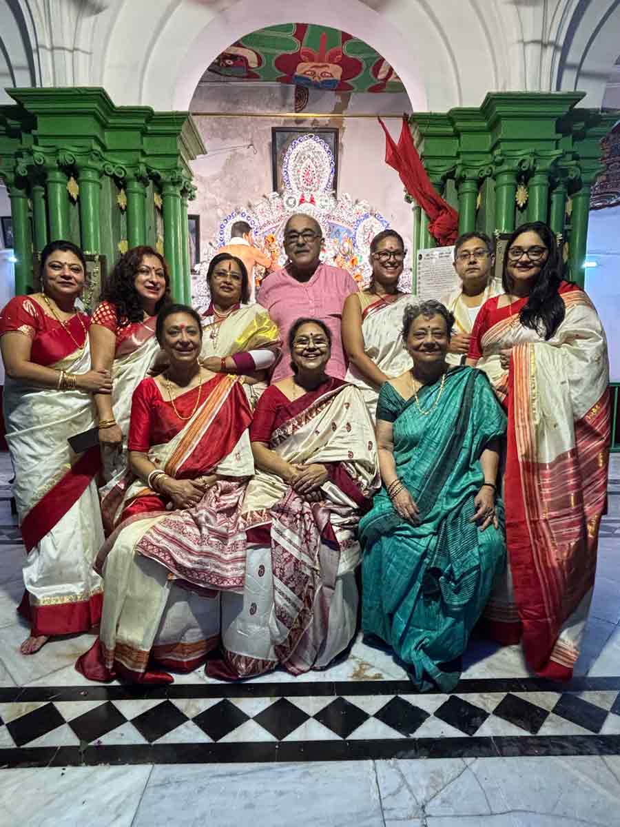 Two generations of the Bose family are pictured here, showcasing some of the individuals without whose contributions the Pujo would not come to life. While each member works in a different field and family gatherings are rare due to conflicting schedules, Durga Puja holds a special place in every family member’s heart, strengthening familial bonds year after year under Maa Durga’s watchful eyes