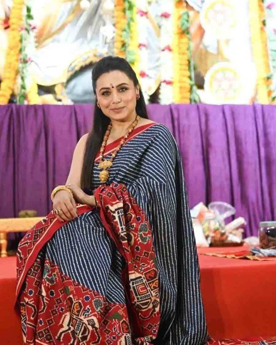 Rani Mukerji stole the spotlight at North Bombay Durga Puja pandal with her black-and-red printed cotton sari. The actress visited the pandal with her mother and exchanged pleasantries with Kajol, Ranbir Kapoor, Adah Sharma and Sumona Chakravarti. 