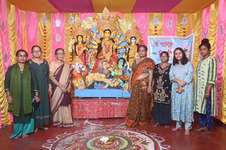 (From left) The employees of Sanlaap, Rita Chakraborty, Mandakini Das, Sumi Bhowmick, Tapoti Bhowmick, Parbati Das, Anamika Chanak and Dipa Dutta pose with the idol, before calling it a night after the celebrations