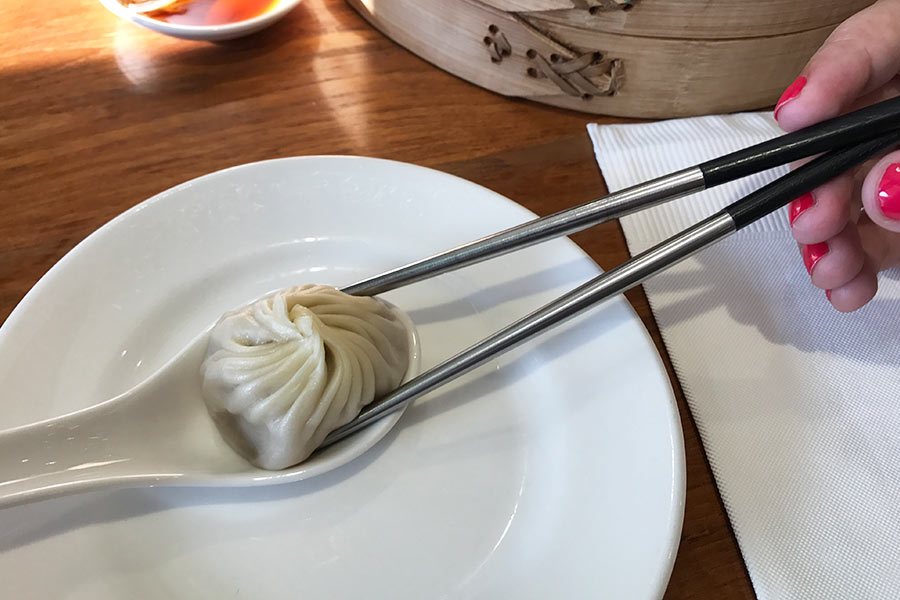 It takes some practice but the best way to have the Xiao Long Bao is using chopsticks and a soup spoon