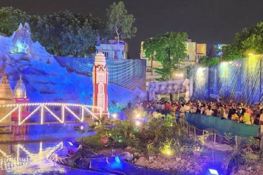 People throng the Ganga ghat portrayed at the FD Block puja