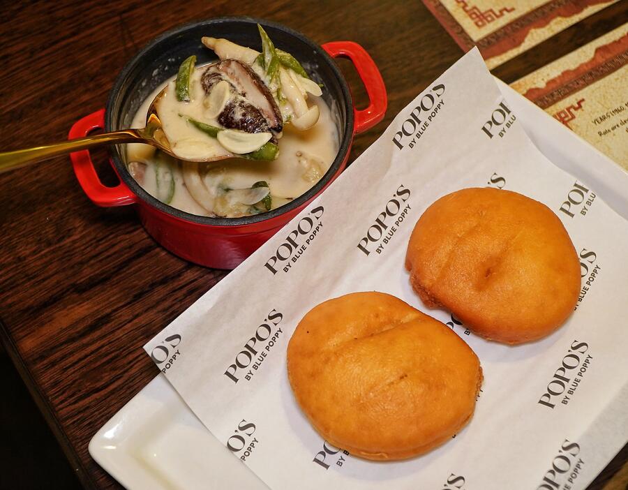 C for comfort, C for cheese. Popo’s version of the Shamu Datshi is a Bhutanese light cheese-based dish loaded with three kinds of mushrooms: Shiitake, Shimeji and Black Fungus. Added to it are slivers of chilli and greens. Pair it with the sour bread buns