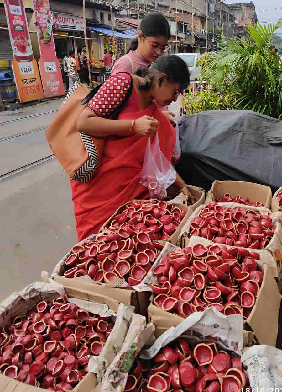 With only a few days left for Kali Puja and Diwali, women at Rabindra Sarani were seen buying 'diyas' (clay lamps)