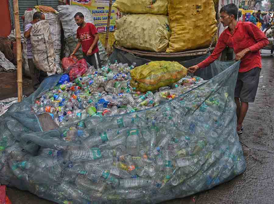 With Durga Puja just over, tonnes of disposable plastic bottles arrive at a shop on Rabindra Sarani for recycling 