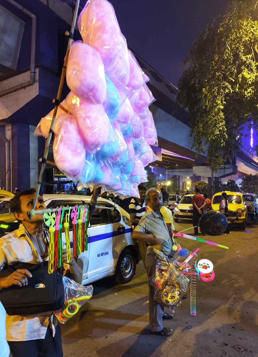 Durga Puja might be over but the attraction candy floss and bubble blowers hold among children is timeless, as seen at the Science City entrance on Saturday evening