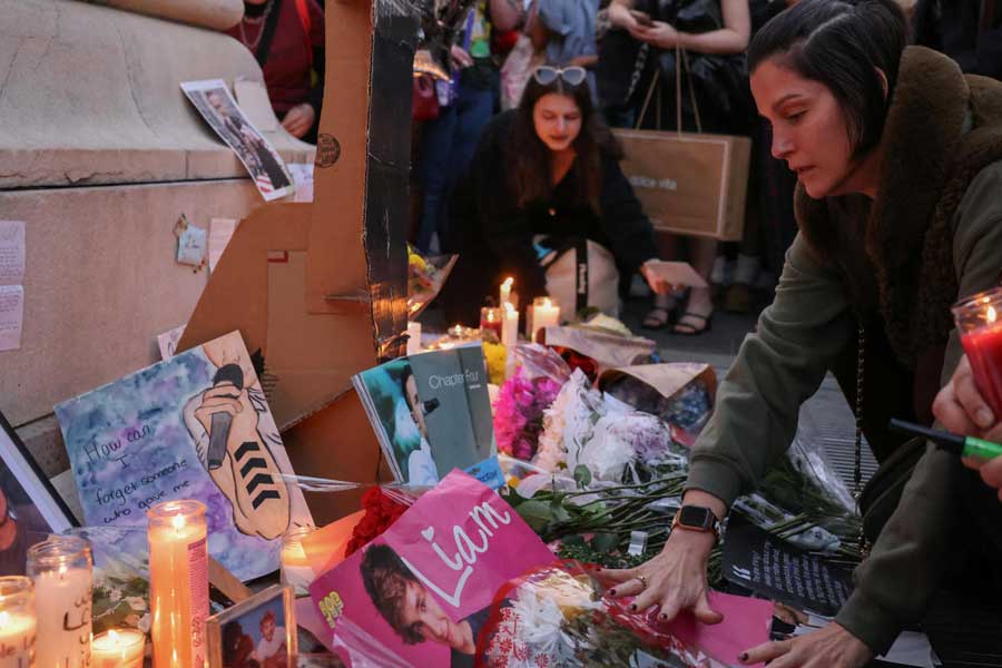 People gather during a vigil to celebrate Liam Payne’s life at Washington Square Park in New York City, U.S., October 19, 2024.