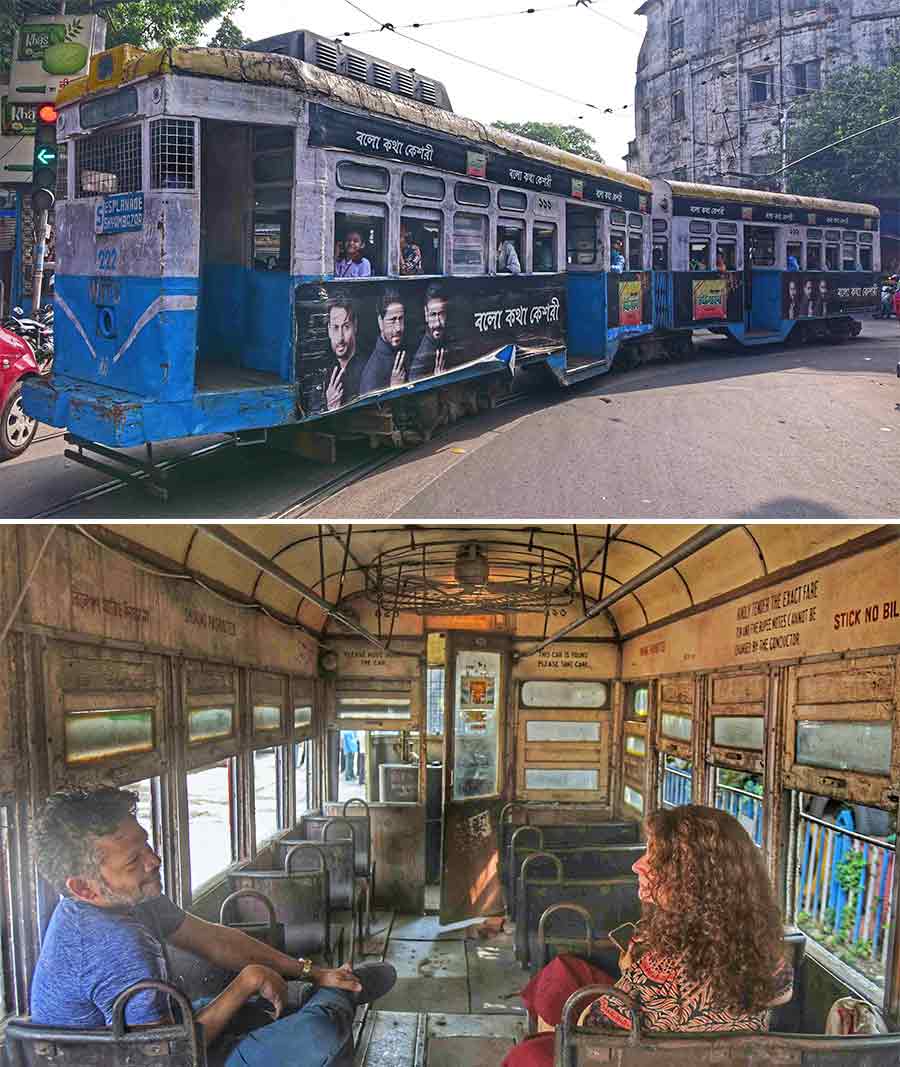 (Top) Tram on route number 5 takes a turn at the Wellington crossing on Lenin Sarani. Tram services resumed in Kolkata on Tuesday after staying suspended during Durga Puja and (above) a couple waits inside a tram at the Esplanade tram depot