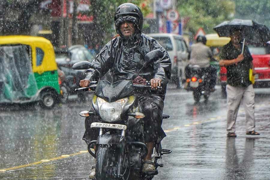 A biker caught in the Wednesday morning shower in Kolkata