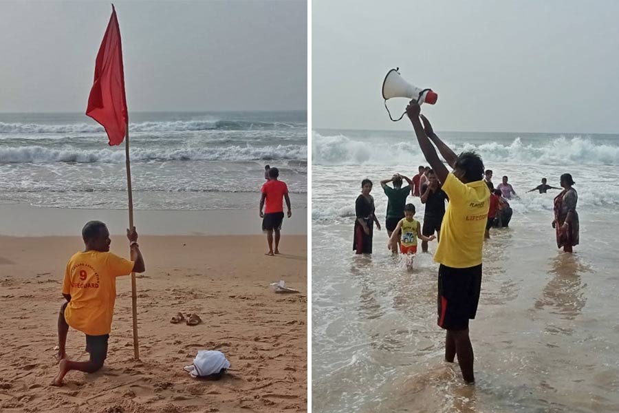 Red flags placed in the danger zone of the golden beach at Puri and a lifeguard warns bathers over the public address system at a nearby spot on Wednesday morning 