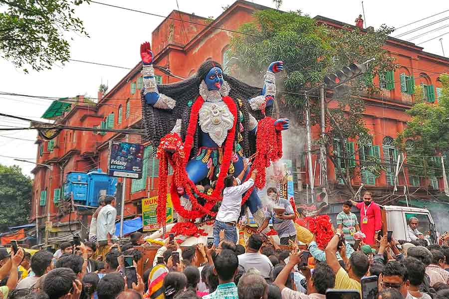 The idol of Fatakesto Kali Puja on its way to the pandal on Wednesday morning