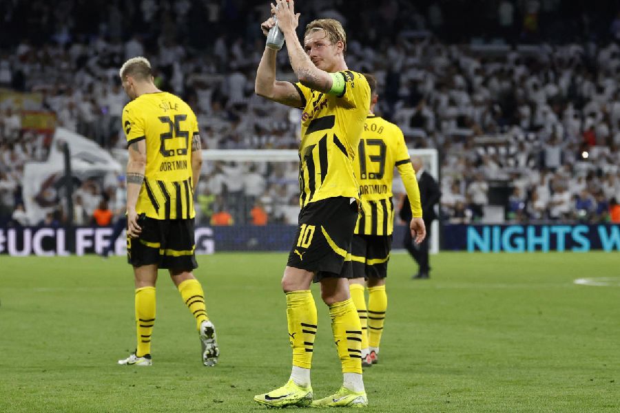 Borussia Dortmund's Julian Brandt applauds fans after the match.